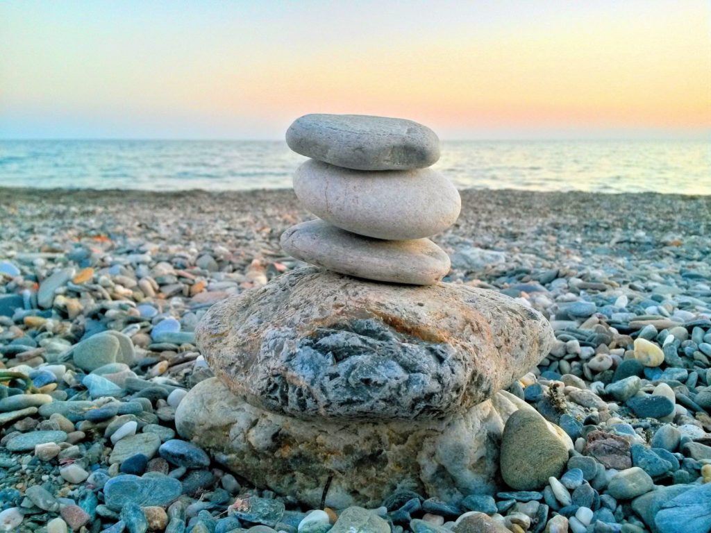 Stones stacked on each other on a beach.