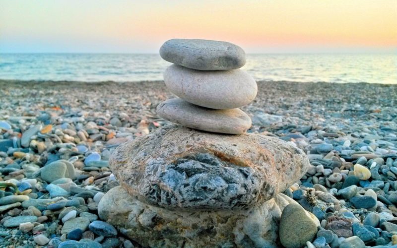 Stones stacked on each other on a beach.